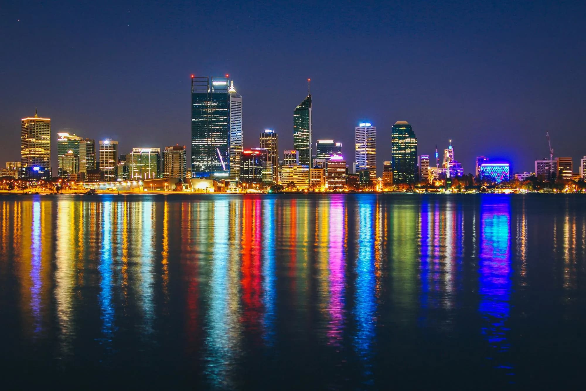 The Perth city skyline at night across the Swan River
