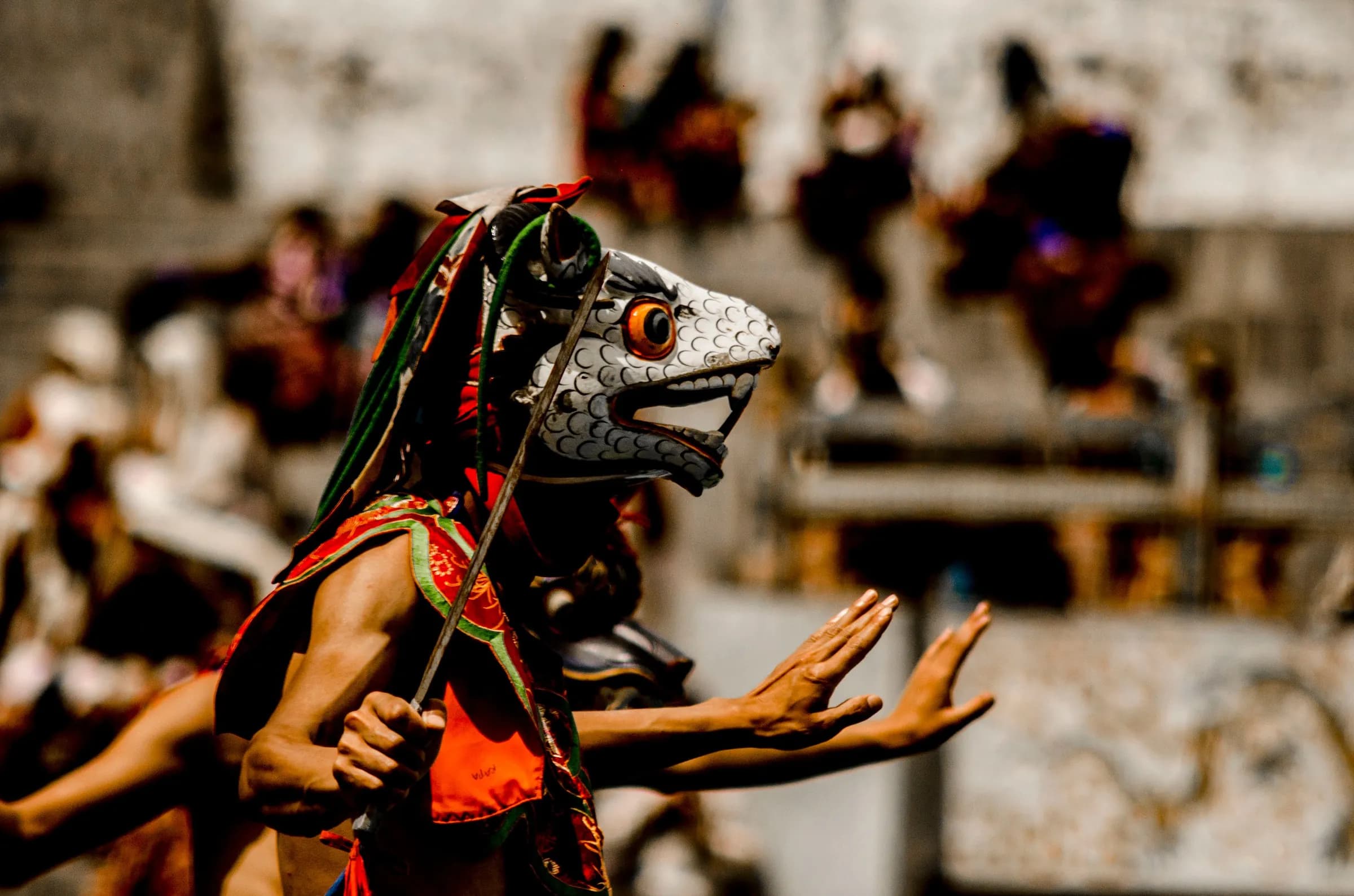 A masked dancer performing at a festival in Thimphu, Bhutan